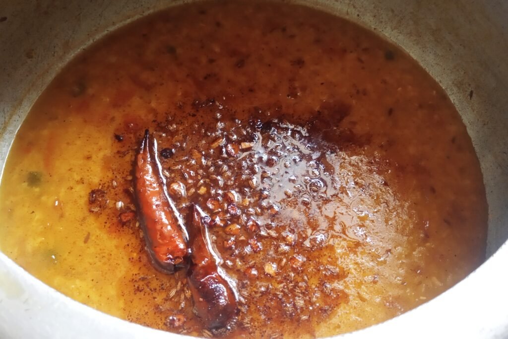 Pour tadka over dal