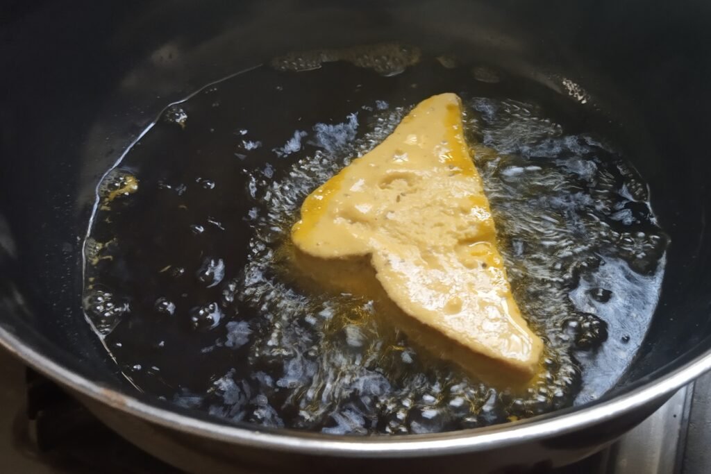 Adding coated bread in oil