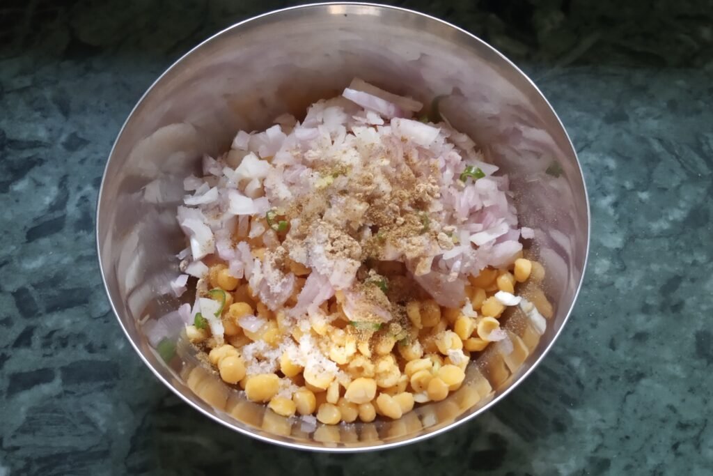 Adding onion chili and spices