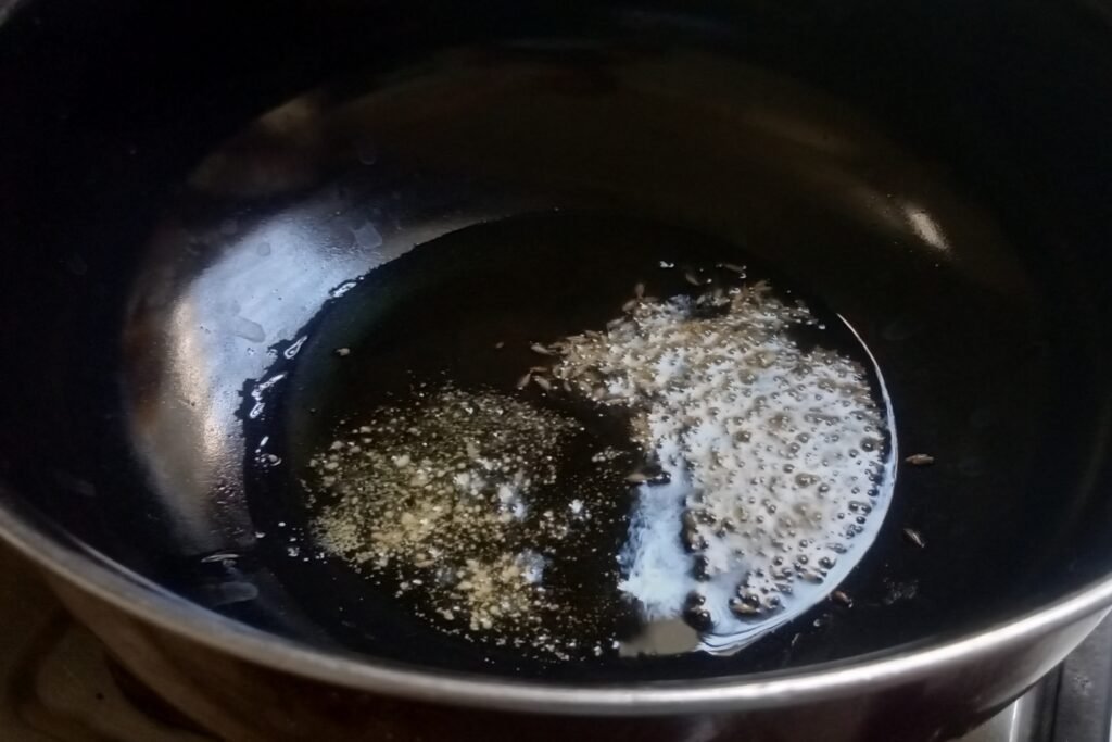 Tempering cumin seeds and asafoetida