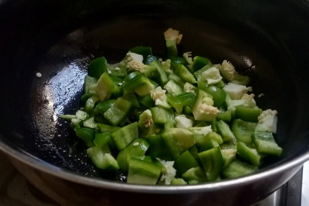 Adding chopped capsicum