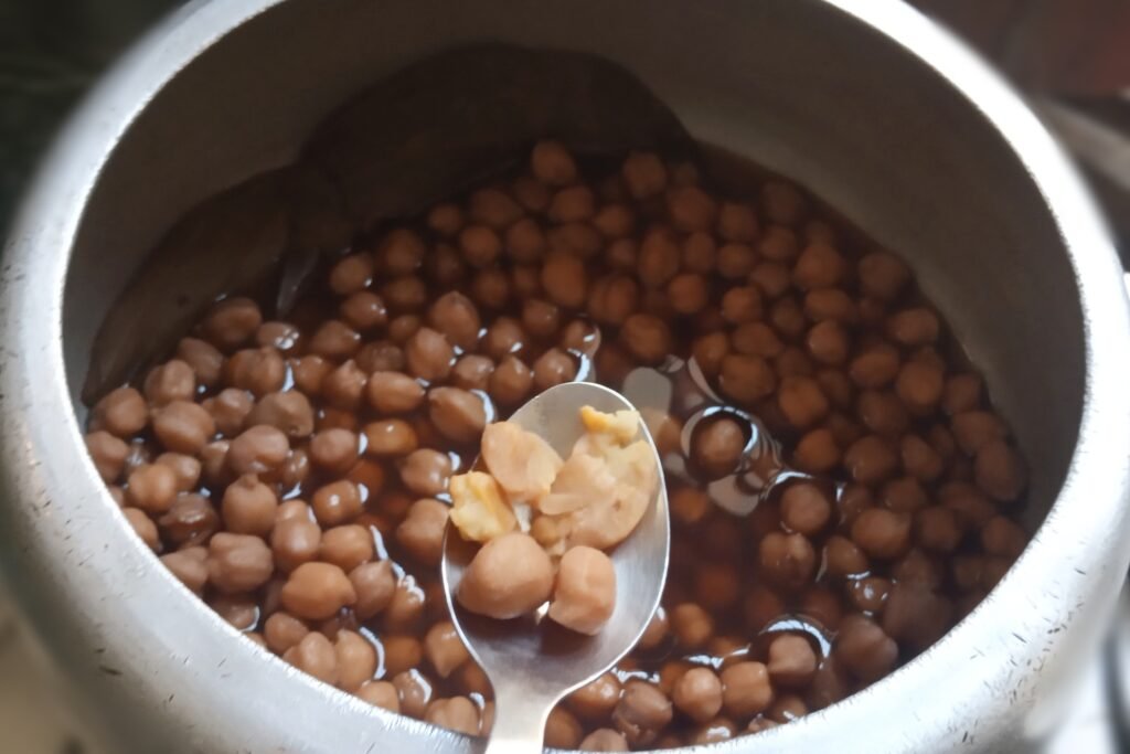 Cooked chickpeas testing in a spoon