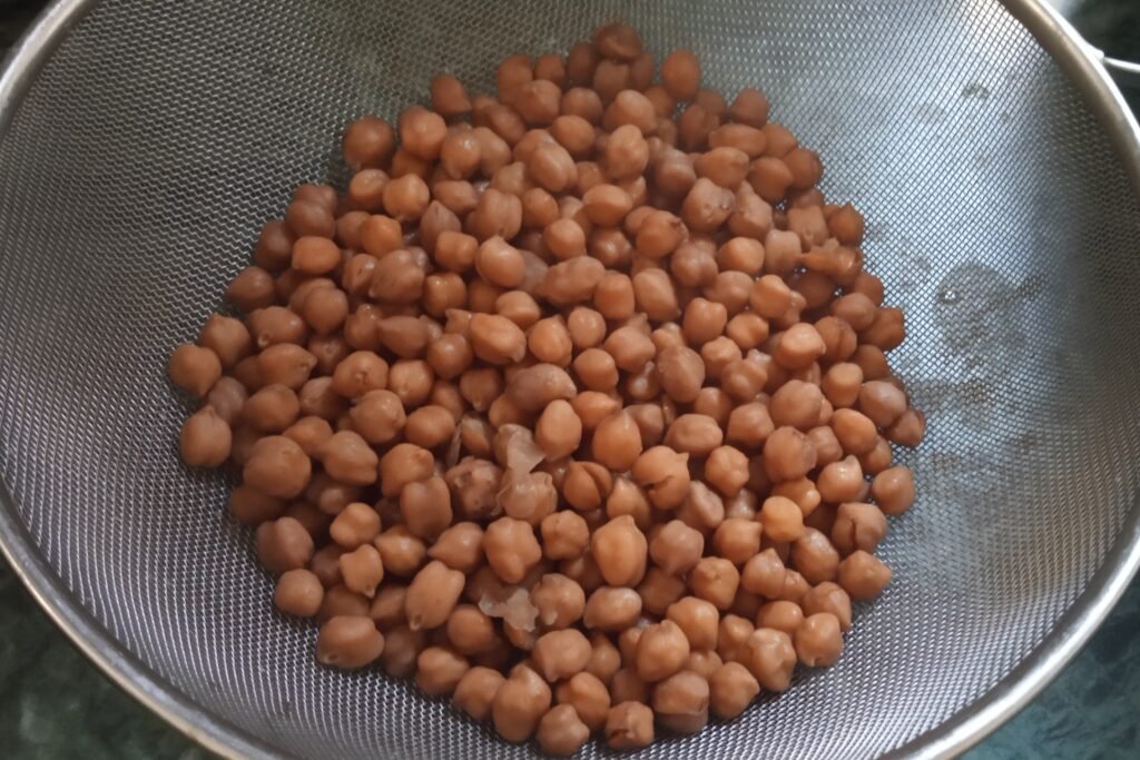 Cooked chickpeas in a strainer