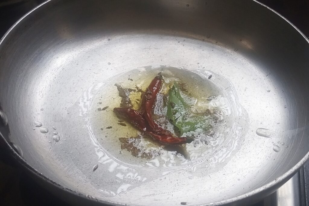 Adding whole spices and curry leaves