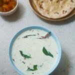 Dahi tadka recipe garnished with curry leaves